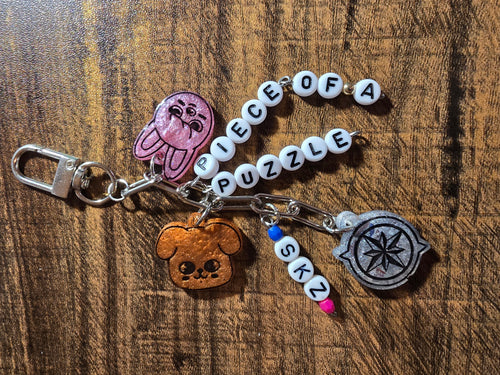 Keychain with various charms on a wooden surface
