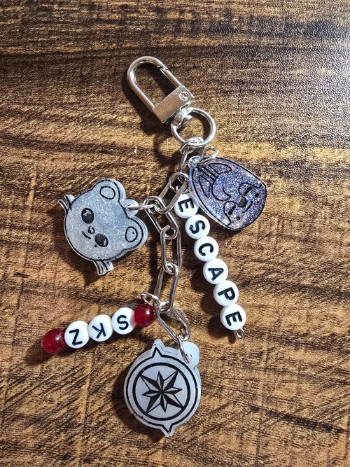 Keychain with various charms on a wooden surface
